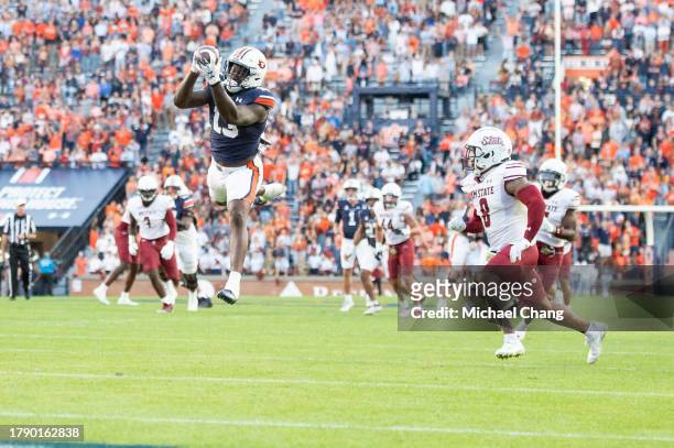 Tight end Rivaldo Fairweather of the Auburn Tigers catches a pass in front of cornerback Andre Seldon of the New Mexico State Aggies during the first...