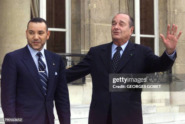 French President Jacques Chirac flanked by King Mohammed VI of Morocco wave as they leave 20 March 2000 the Elysee Palace in Paris. King Mohammed VI...
