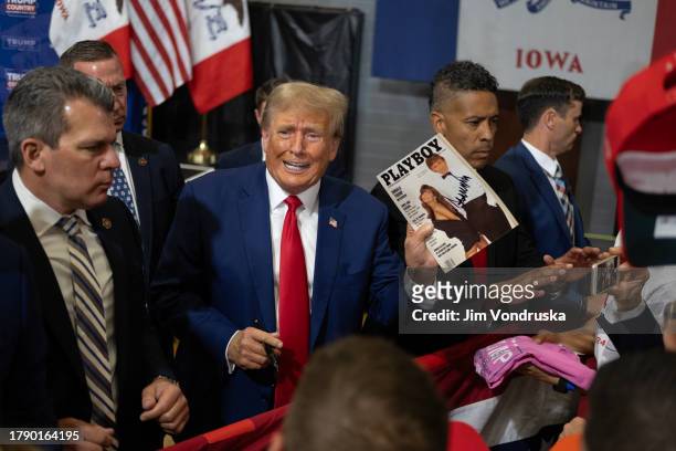 Former President Donald Trump signs items for a crowd of supporters at the Fort Dodge Senior High School on November 18, 2023 in Fort Dodge, Iowa....