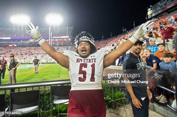 Offensive lineman AJ Vaipulu of the New Mexico State Aggies celebrates after defeating the Auburn Tigers at Jordan-Hare Stadium on November 18, 2023...