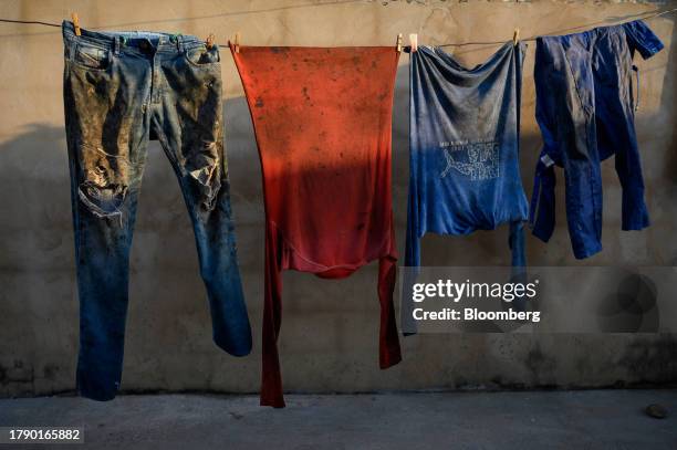Fishermen's clothes covered in oil are hung out to dry near Lake Maracaibo in Cabimas, Zulia state, Venezuela, on Friday, Nov. 17, 2023....