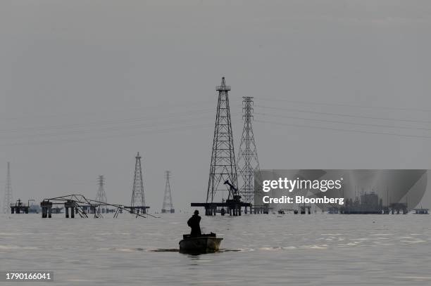 Fishermen in front of Petroleos de Venezuela SA oil rigs on Lake Maracaibo in Cabimas, Zulia state, Venezuela, on Wednesday, Nov. 15, 2023....