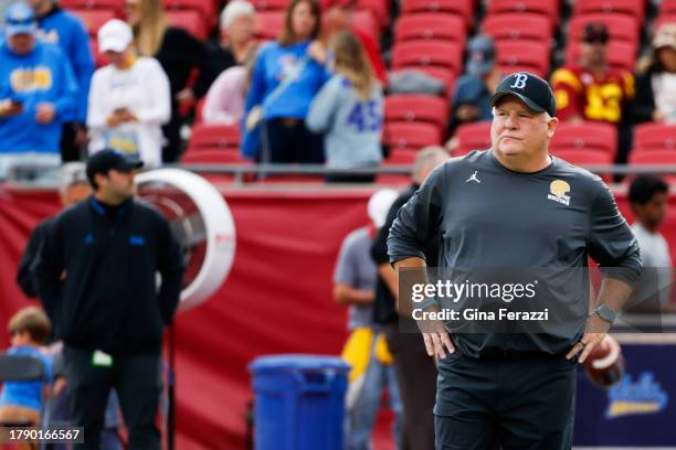 Bruins head coach Chip Kelly watches pregame warm ups before the game against the USC Trojans at Los Angeles Memorial Coliseum on Saturday, Nov. 18,...