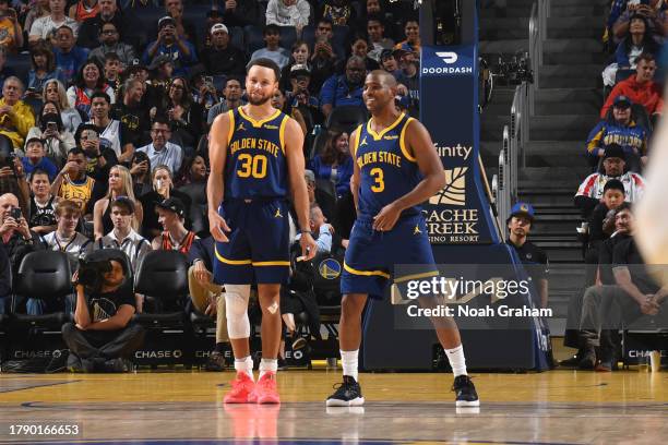 Stephen Curry and Chris Paul of the Golden State Warriors smile during the game against the Oklahoma City Thunder on November 18, 2023 at Chase...