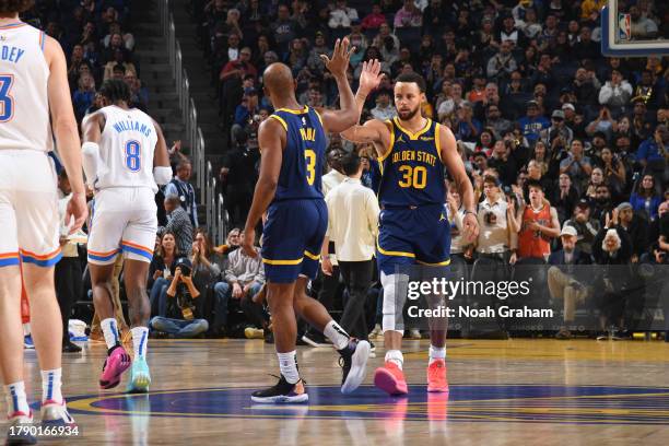 Stephen Curry and Chris Paul of the Golden State Warriors high five during the game against the Oklahoma City Thunder on November 18, 2023 at Chase...