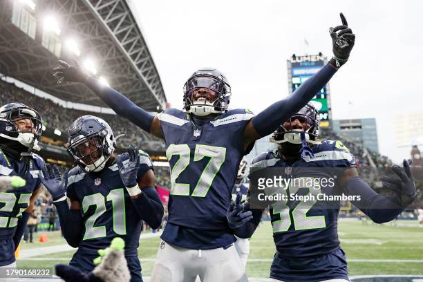 Devon Witherspoon of the Seattle Seahawks, Riq Woolen of the Seattle Seahawks, and Jerrick Reed II of the Seattle Seahawks celebrate after Woolen's...