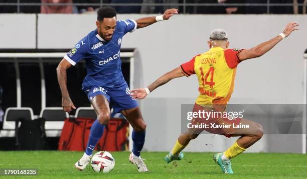 Pierre-Emerick Aubameyang in action with Facundo Medina of Lens during the Ligue 1 Uber Eats match between RC Lens and Olympique de Marseille at...