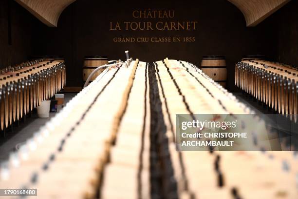 This photograph taken on October 18, 2023 shows wine barrels in the cellar of the Chateau La Tour Carnet in Saint-Laurent-Medoc, southwestern France....