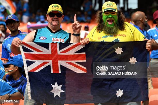 Fans hold national flag as they cheer for Australian team before the start of the 2023 ICC Men's Cricket World Cup one-day international final match...