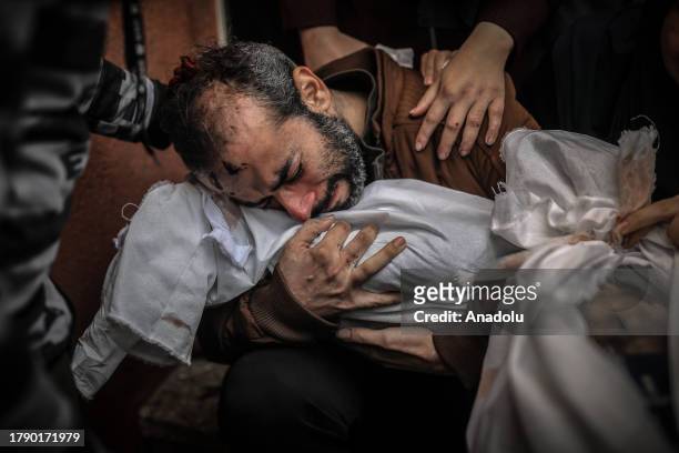 Jemil and his wife holding the lifeless body of his child shed tears following the bodies of his children are taken from Nasser Hospital on the 44th...