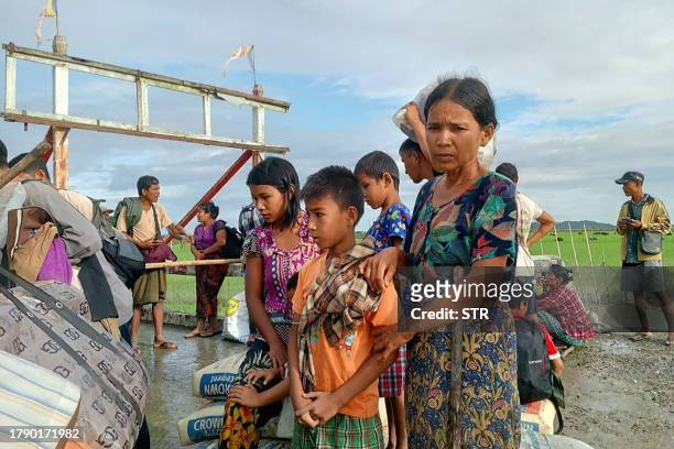 People flee from a village after renewed fighting between Myanmar's military and the Arakan Army , an ethnic minority armed group, in Pauktaw...