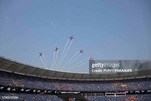 The Indian Air Force Surya Kiran aerobatics team performs before the start of the 2023 ICC Men's Cricket World Cup one-day international final match...