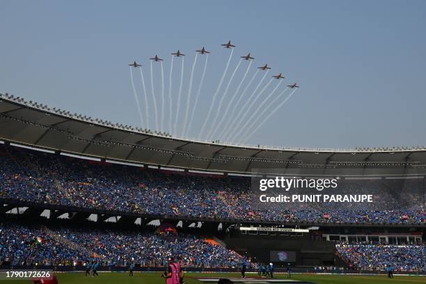 The Indian Air Force Surya Kiran aerobatics team performs before the start of the 2023 ICC Men's Cricket World Cup one-day international final match...