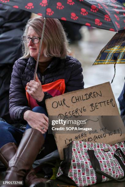 Protester holds a placard saying 'Our Children Deserve Better'. Supporters of Extinction Rebellion Families meet to highlight the need to change how...