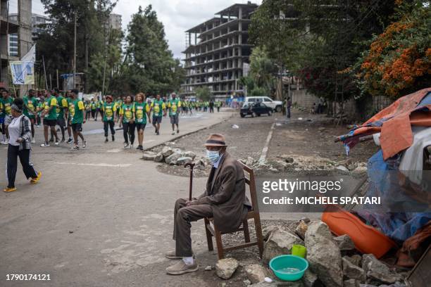 An elderly man watches people taking part in the 23rd edition of the Great Ethiopian Run in Addis Ababa on November 19, 2023. The Great Ethiopian Run...