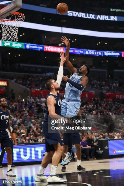 Jaren Jackson Jr. #13 of the Memphis Grizzlies shoots defended by Ivica Zubac of the LA Clippers in the first half at Crypto.com Arena on November...