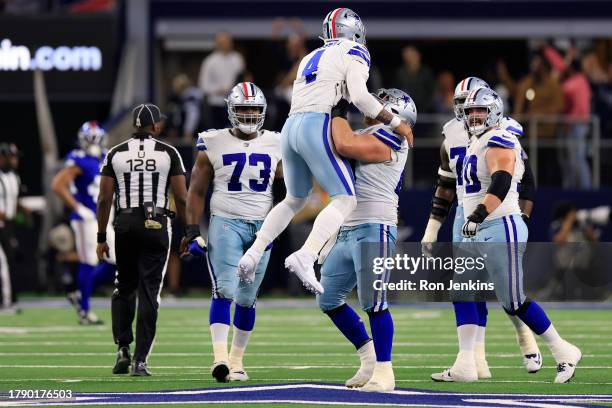 Dak Prescott of the Dallas Cowboys celebrates with teammates after a touchdown pass during the third quarter against the New York Giants at AT&T...