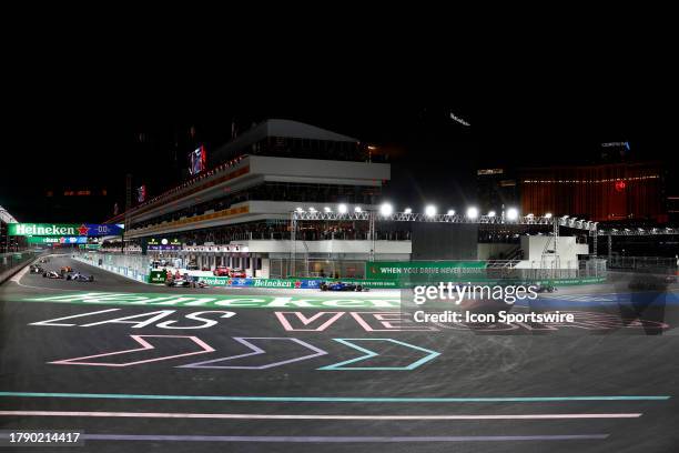 General view of cars racing through turn 1 with the paddock and garage building in the background during the inaugural Formula 1 Heineken Silver Las...