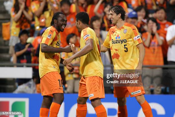 Peter Utaka of Shimizu S-Pulse celebrates with teammates Calvin Jong-a-Pin and Dejan Jakovic after scoring his team's first goal during the J.League...