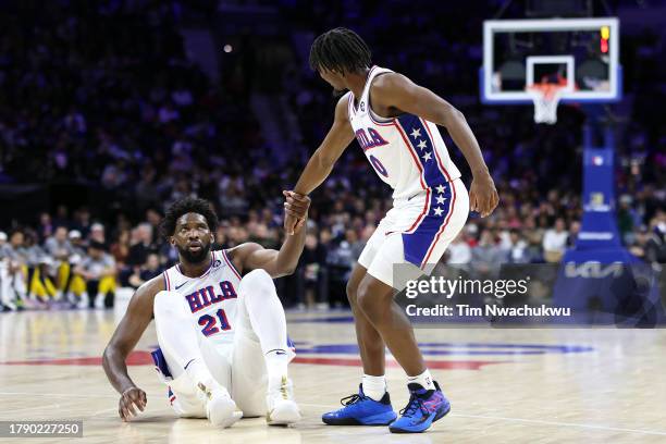 Tyrese Maxey of the Philadelphia 76ers assists Joel Embiid during the second quarter against the Indiana Pacers at the Wells Fargo Center on November...