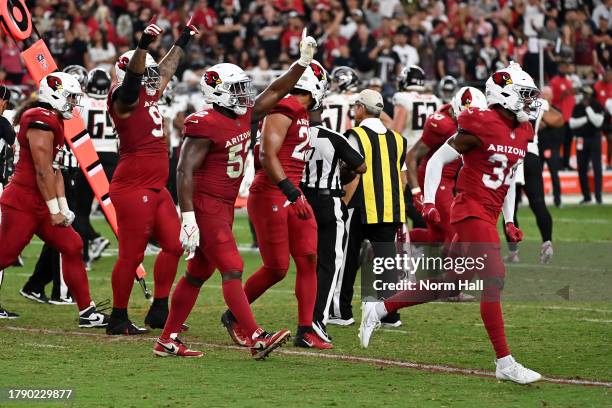 The Arizona Cardinals celebrate after stopping the Atlanta Falcons on a fourth down during the fourth quarter at State Farm Stadium on November 12,...