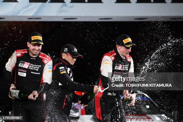 Toyota Motors chairman Akio Toyota sprays sparkling Sake with Elfyn Evans and his co-driver Scott Martin of Great Britain during the podium ceremony...