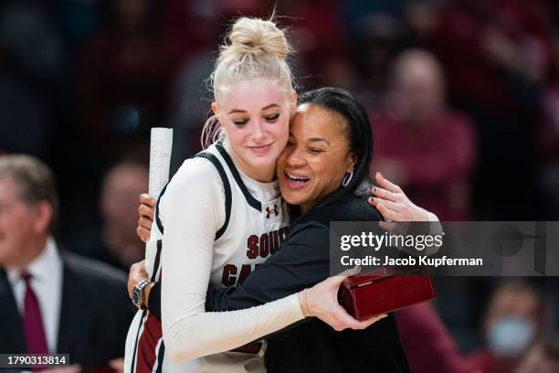 Chloe Kitts of the South Carolina Gamecocks hugs head coach Dawn Staley during a ring ceremony for last season's SEC and Final Four performances...