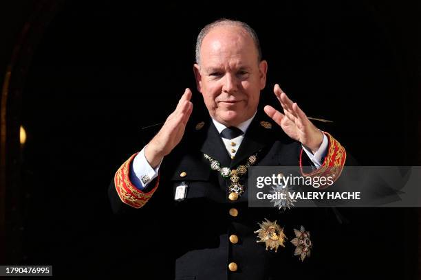 Prince Albert II of Monaco gestures from the balcony of the Prince's Palace of Monaco during a ceremony marking the National Day in Monaco, on...