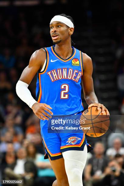 Shai Gilgeous-Alexander of the Oklahoma City Thunder controls the ball against the Phoenix Suns during the first half at Footprint Center on November...
