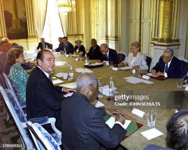 French President Jacques Chirac sits next to the former president of Benin, Derlin Zimsou and across from Francophone High Council Secretary-General...