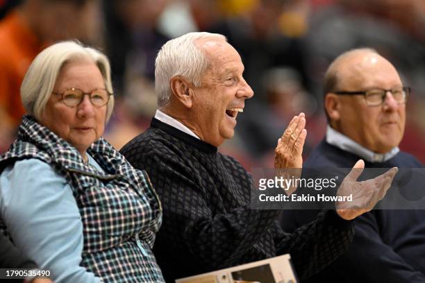 Former North Carolina Tar Heels coach Roy Williams sits courtside during the first half at Harrah's Cherokee Center on November 10, 2023 in...