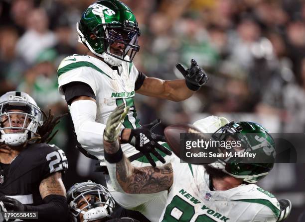 Wide receiver Garrett Wilson and tight end Tyler Conklin of the New York Jets fail to pull down the Hail Mary pass on the final play of the game...