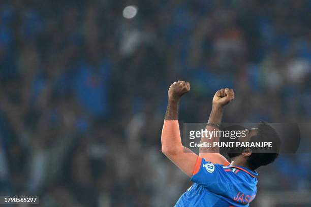 India's Jasprit Bumrah celebrates after taking the wicket of Australia's Mitchell Marsh during the 2023 ICC Men's Cricket World Cup one-day...