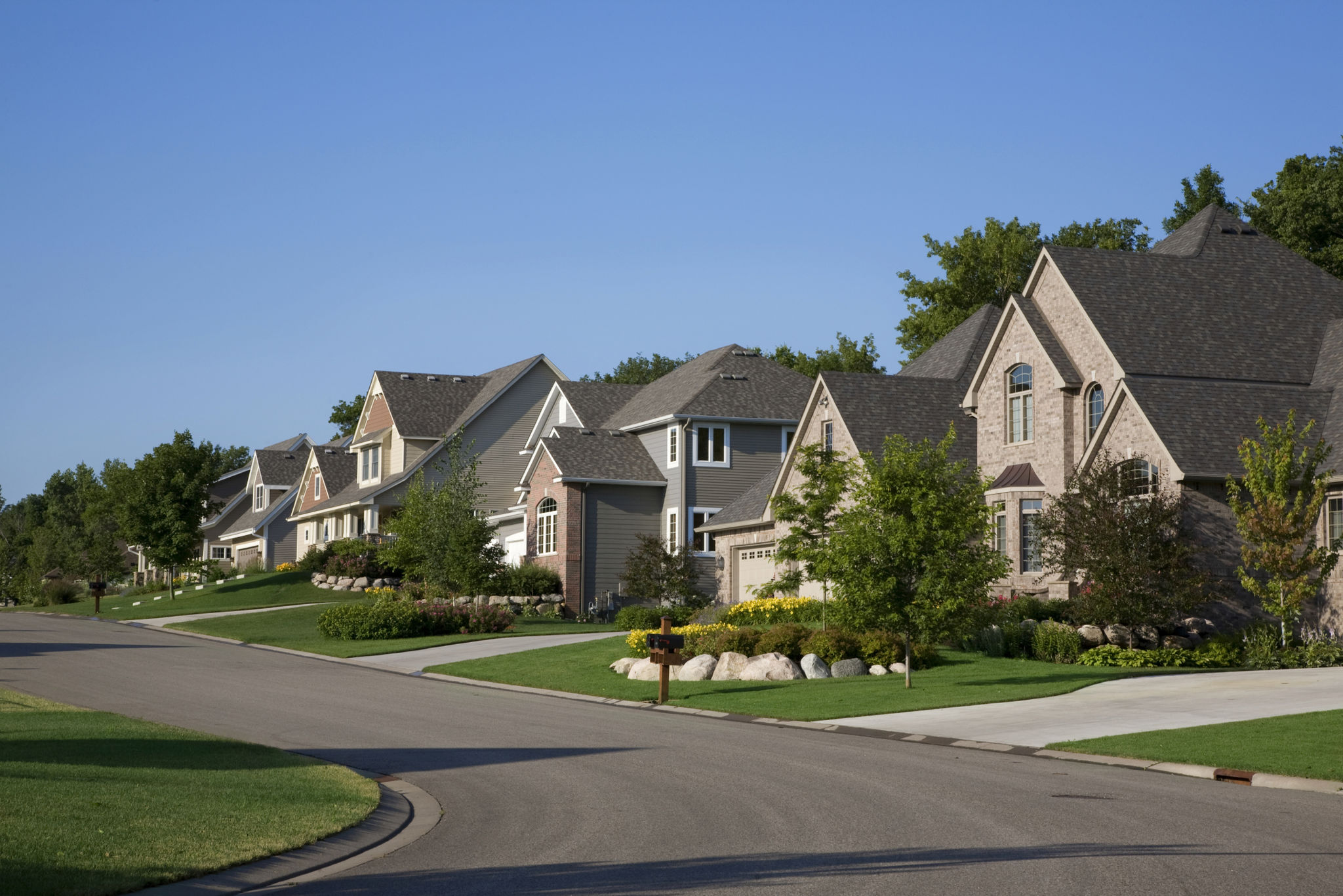 Upscale houses on suburban street Upscale houses on suburban street