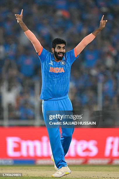 India's Jasprit Bumrah celebrates after taking the wicket of Australia's Mitchell Marsh during the 2023 ICC Men's Cricket World Cup one-day...