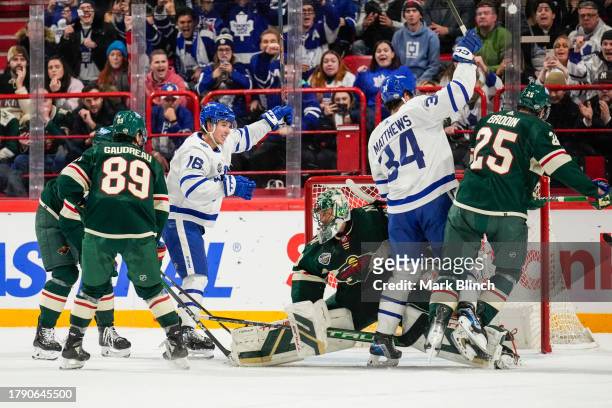 Auston Matthews of the Toronto Maple Leafs celebrates his goal against Marc-Andre Fleury of the Minnesota Wild with teammate Mitchell Marner during...
