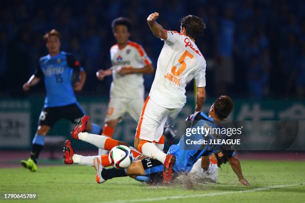 Dejan Jakovic of Shimizu S-Pulse is tackled by Yoshito Okubo of Kawasaki Frontale during the J.League J1 second stage match between Kawasaki Frontale...