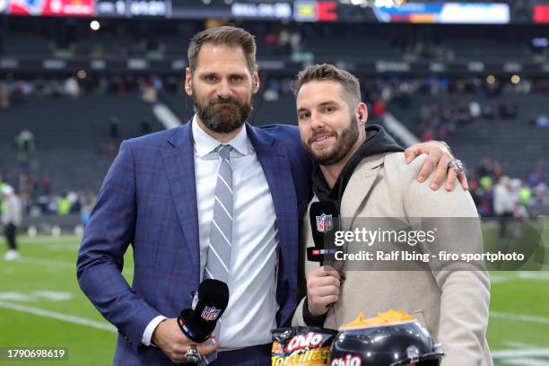 Former NFL players Sebastian Vollmer and Björn Werner look on ahead of the NFL match between Indianapolis Colts and New England Patriots at Deutsche...
