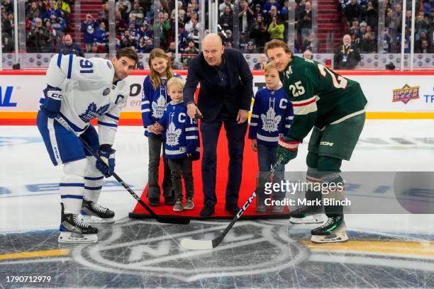 Mats Sundin takes part in a ceremonial face-off alongside John Tavares of the Toronto Maple Leafs and Jonas Brodin of the Minnesota Wild during the...