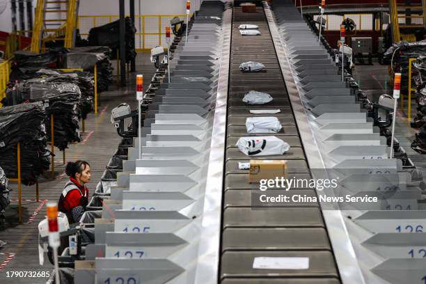 Express packages move on automatic sorting facilities at a distribution center of SF Express after Double 11 shopping festival on November 12, 2023...