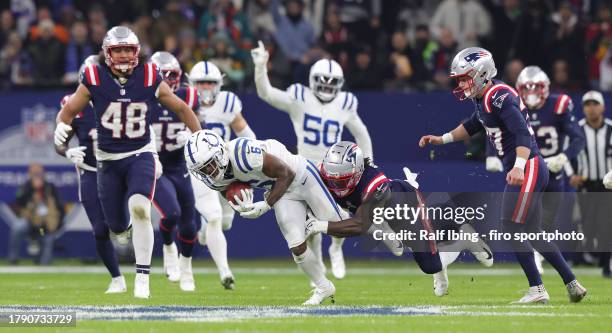 Isaiah McKenzie of Indianapolis Colts and Ty Montgomery II of New England Patriots compete for the ball during the NFL match between Indianapolis...