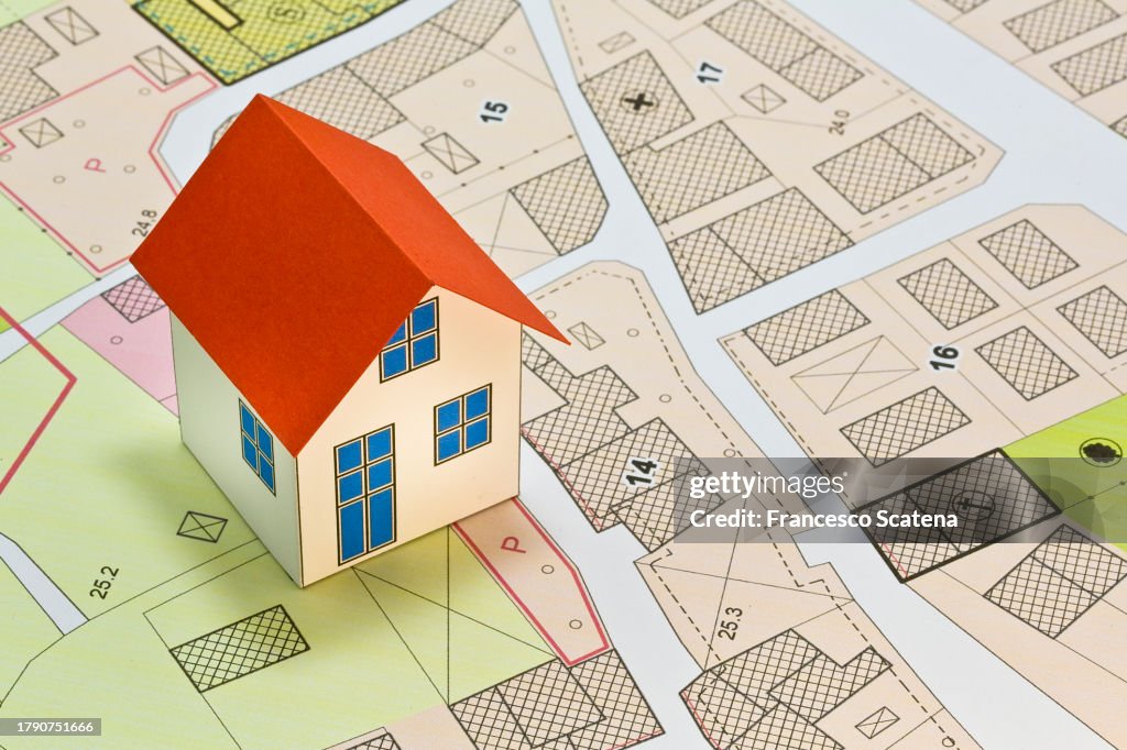 New home and free vacant land for building activity - Construction industry and building permit concept with a residential area, cadastral map, General Urban Planning and zoning regulations
