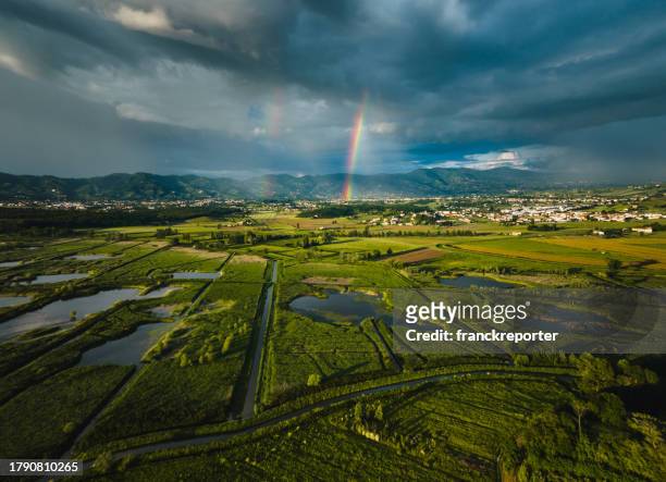 rainbow in the countryside - spring weather stock pictures, royalty-free photos & images