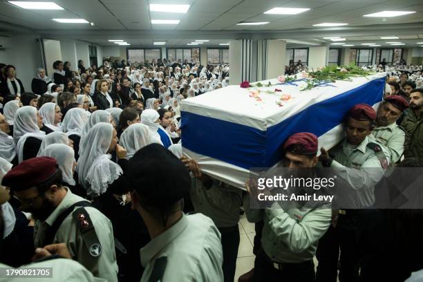 Soldiers carry the coffin of fallen Israeli-Druse soldier, Major Jamal Abbas, who was killed in the Gaza Strip, during his funeral on November 19,...