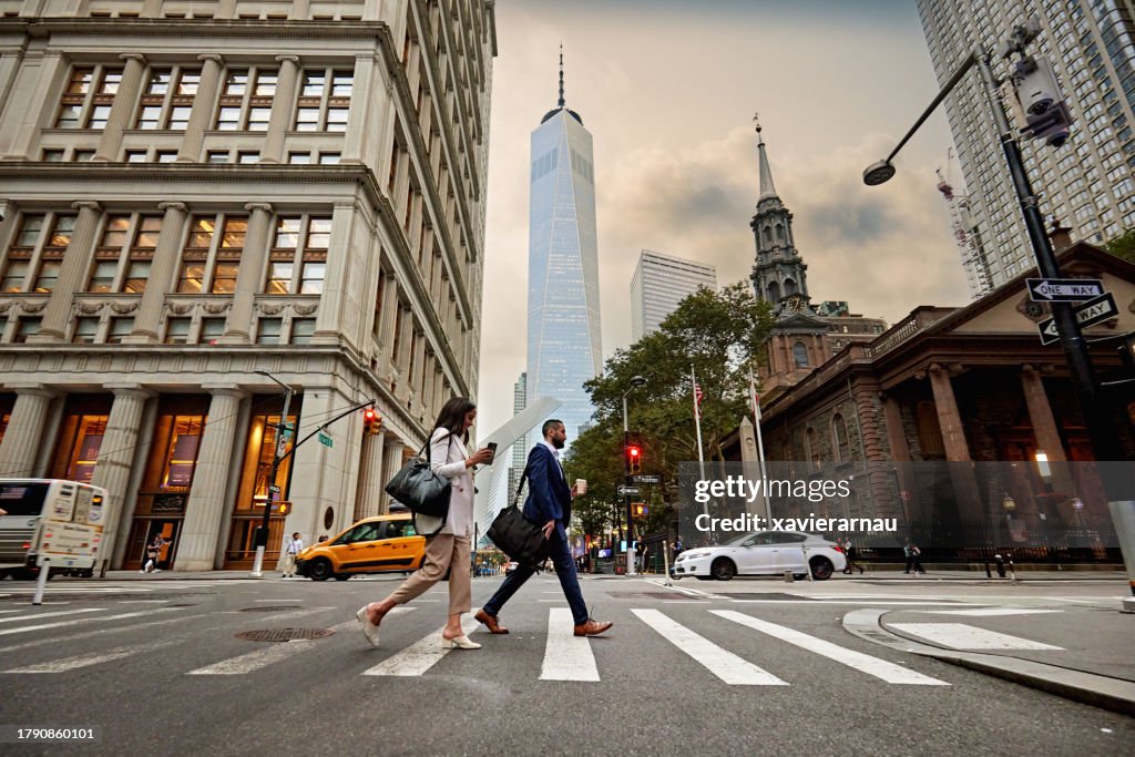 Business people crossing Fulton Street in Lower Manhattan