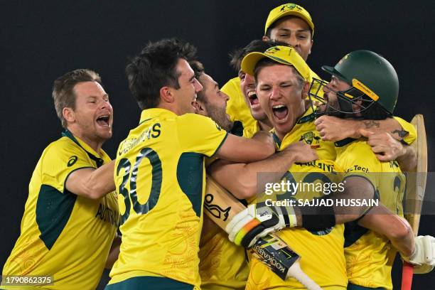 Australian players celebrate after winning the 2023 ICC Men's Cricket World Cup one-day international final match between India and Australia at the...