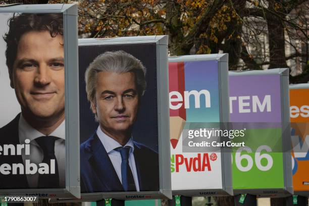 Picture of far-right Dutch politician Geert Wilders is displayed on a poster for his Party for Freedom near the Dutch parliament building is pictured...