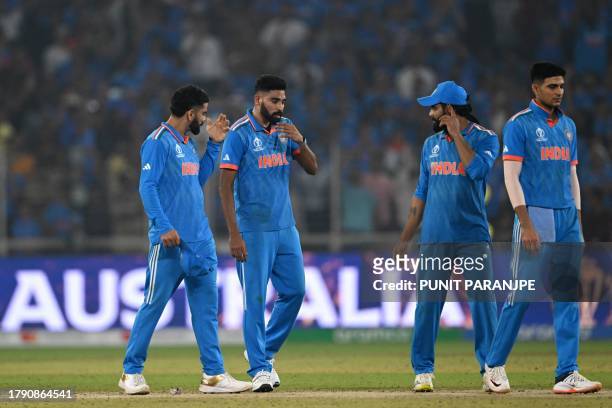 India's players react as they walk back to the pavilion at the end of the 2023 ICC Men's Cricket World Cup one-day international final match between...