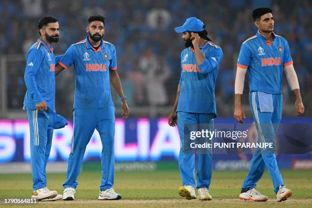 India's players react as they walk back to the pavilion at the end of the 2023 ICC Men's Cricket World Cup one-day international final match between...