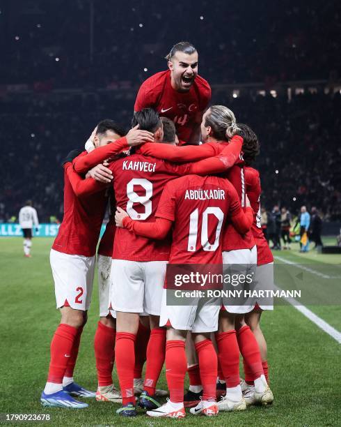 Turkey's players celebrate scoring during the international friendly football match between Germany and Turkey at the Olympic Stadium in Berlin on...